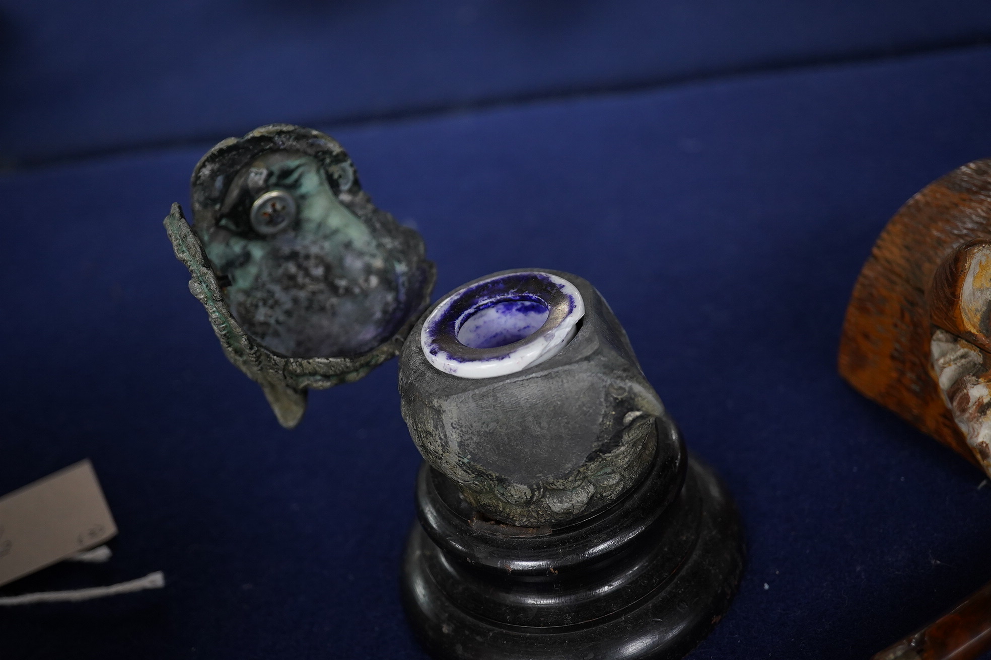 Two carved wood novelty inkwells in the form of animals, one with pen, together with a lead owl inkwell, largest 9cm high. Condition - fair